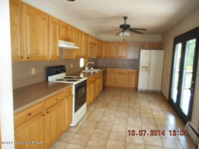 243 Akiba Road Stroudsburg, PA 18360 - Photo 8 of 17 a kitchen with a sink stove and cabinets