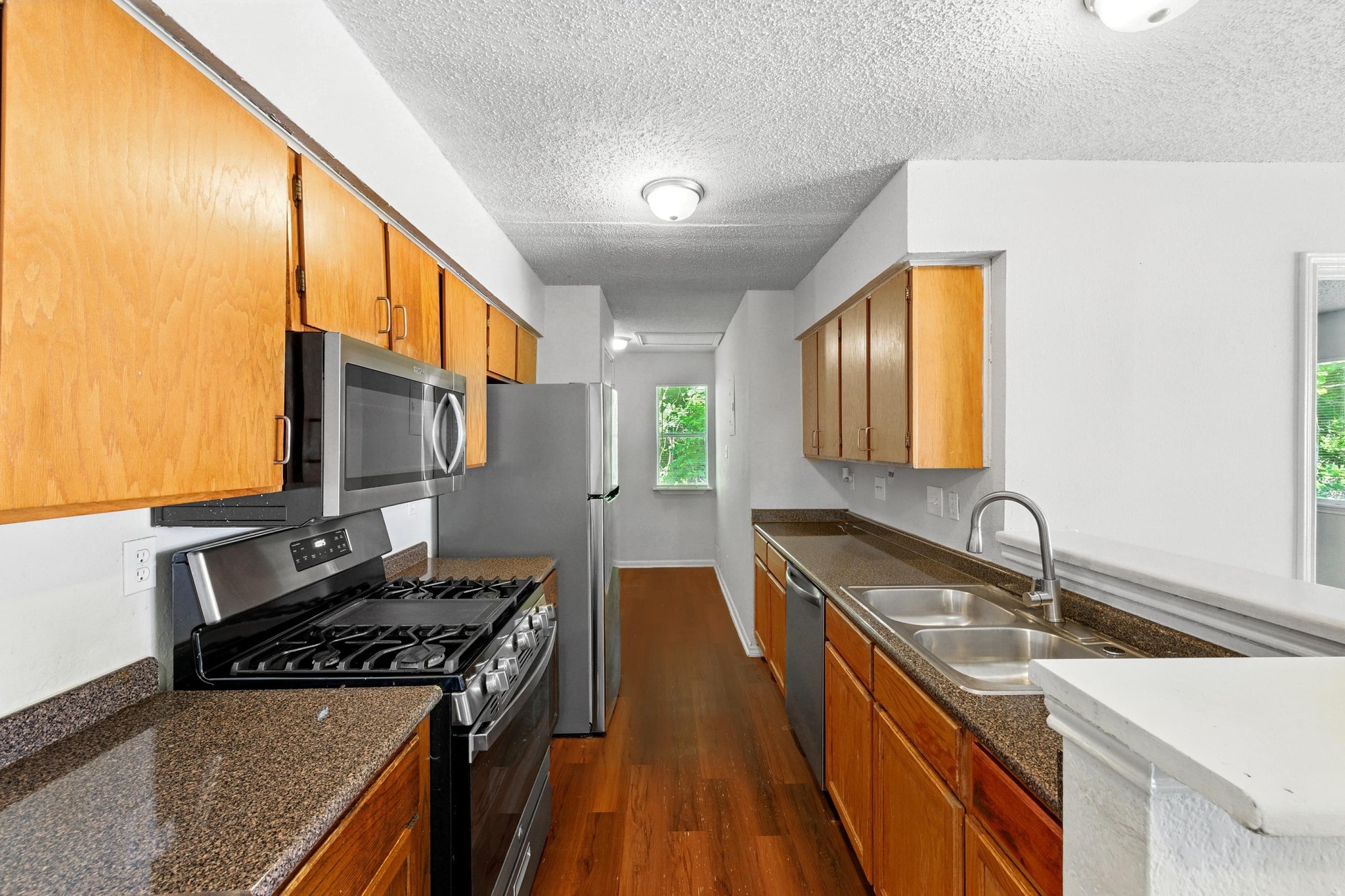 5707 Spring Meadow Road Austin, TX 78744 - Photo 11 of 21 a kitchen with sink stove and cabinets