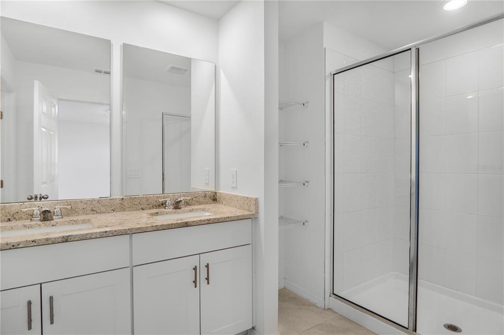 4319 Ranch House Road St. Cloud, FL 34772 - Photo 26 of 47 a bathroom with a granite countertop sink and a mirror
