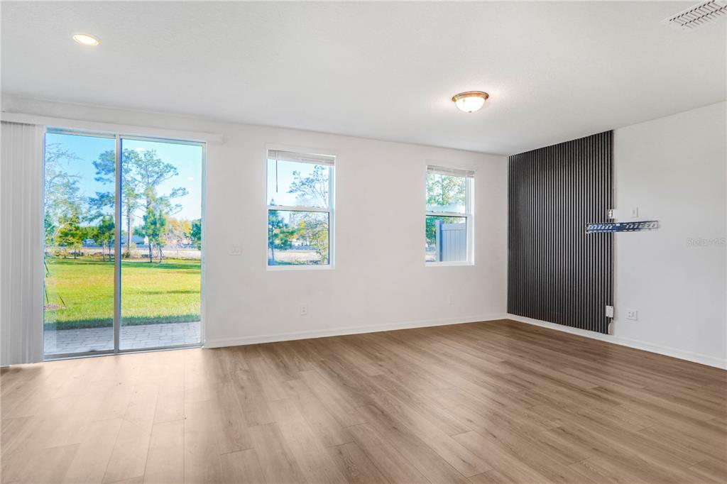 4319 Ranch House Road St. Cloud, FL 34772 - Photo 3 of 47 an empty room with wooden floor and windows
