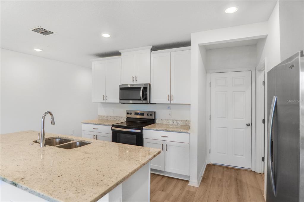 4319 Ranch House Road St. Cloud, FL 34772 - Photo 6 of 47 a kitchen with stainless steel appliances a sink a stove a refrigerator and cabinets