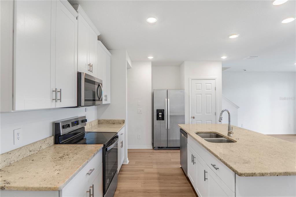 4319 Ranch House Road St. Cloud, FL 34772 - Photo 8 of 47 a kitchen with stainless steel appliances granite countertop a sink stove and refrigerator