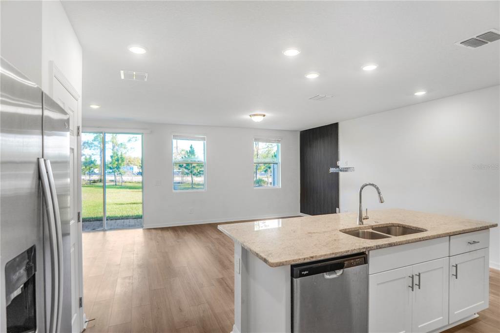 4319 Ranch House Road St. Cloud, FL 34772 - Photo 9 of 47 a kitchen with granite countertop a sink and a refrigerator