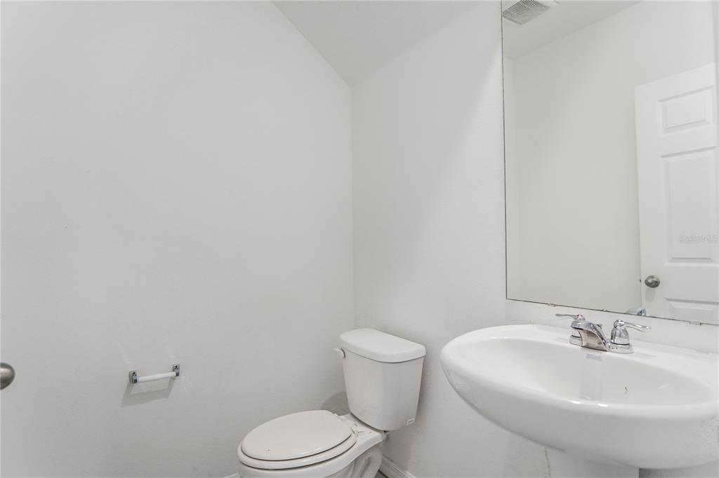 4319 Ranch House Road St. Cloud, FL 34772 - Photo 10 of 47 a bathroom with a sink a toilet and mirror