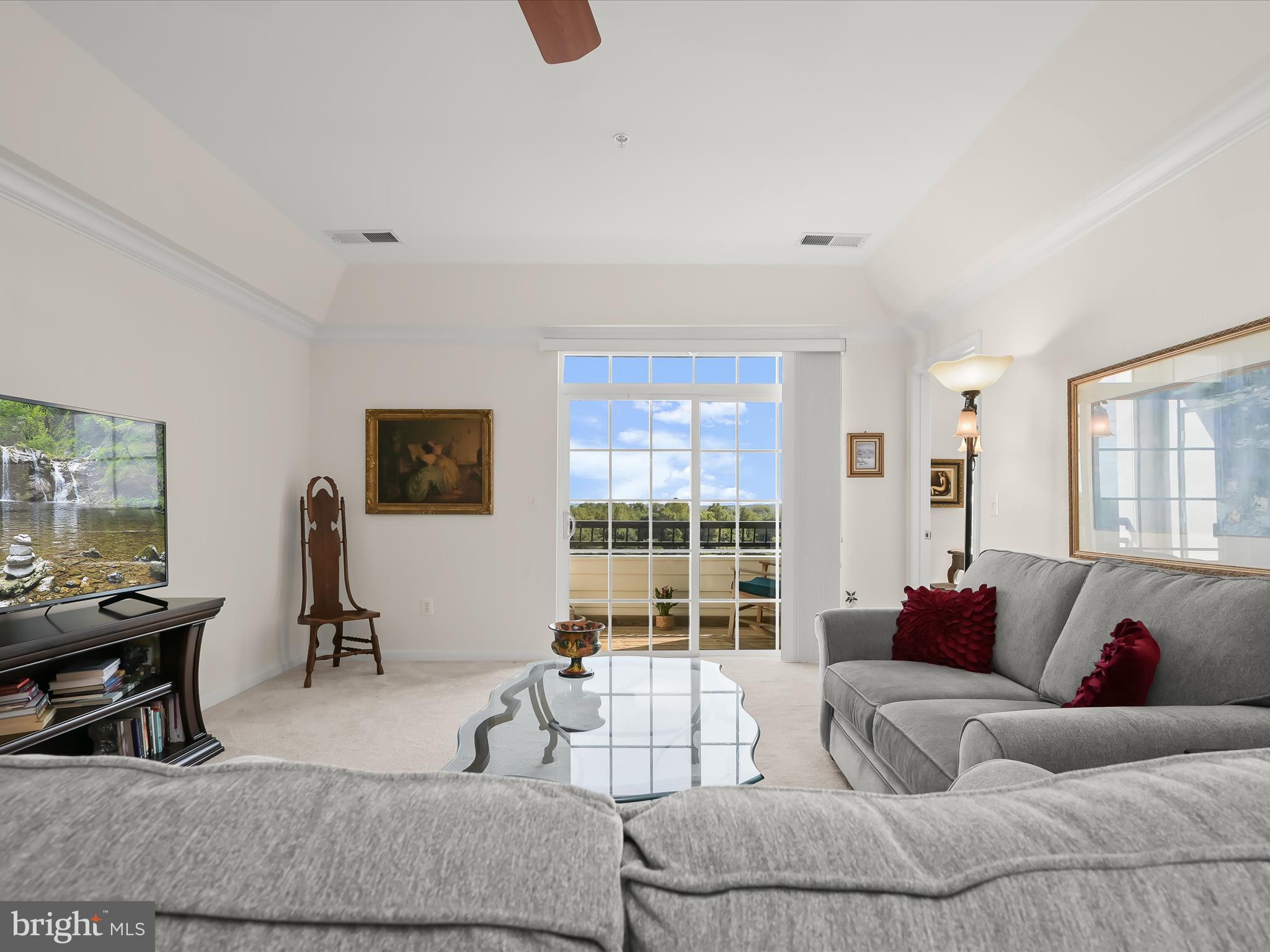 7325 Brookview Road, Unit 305 Elkridge, MD 21075 - Photo 15 of 40 a living room with furniture and a flat screen tv with wooden floor