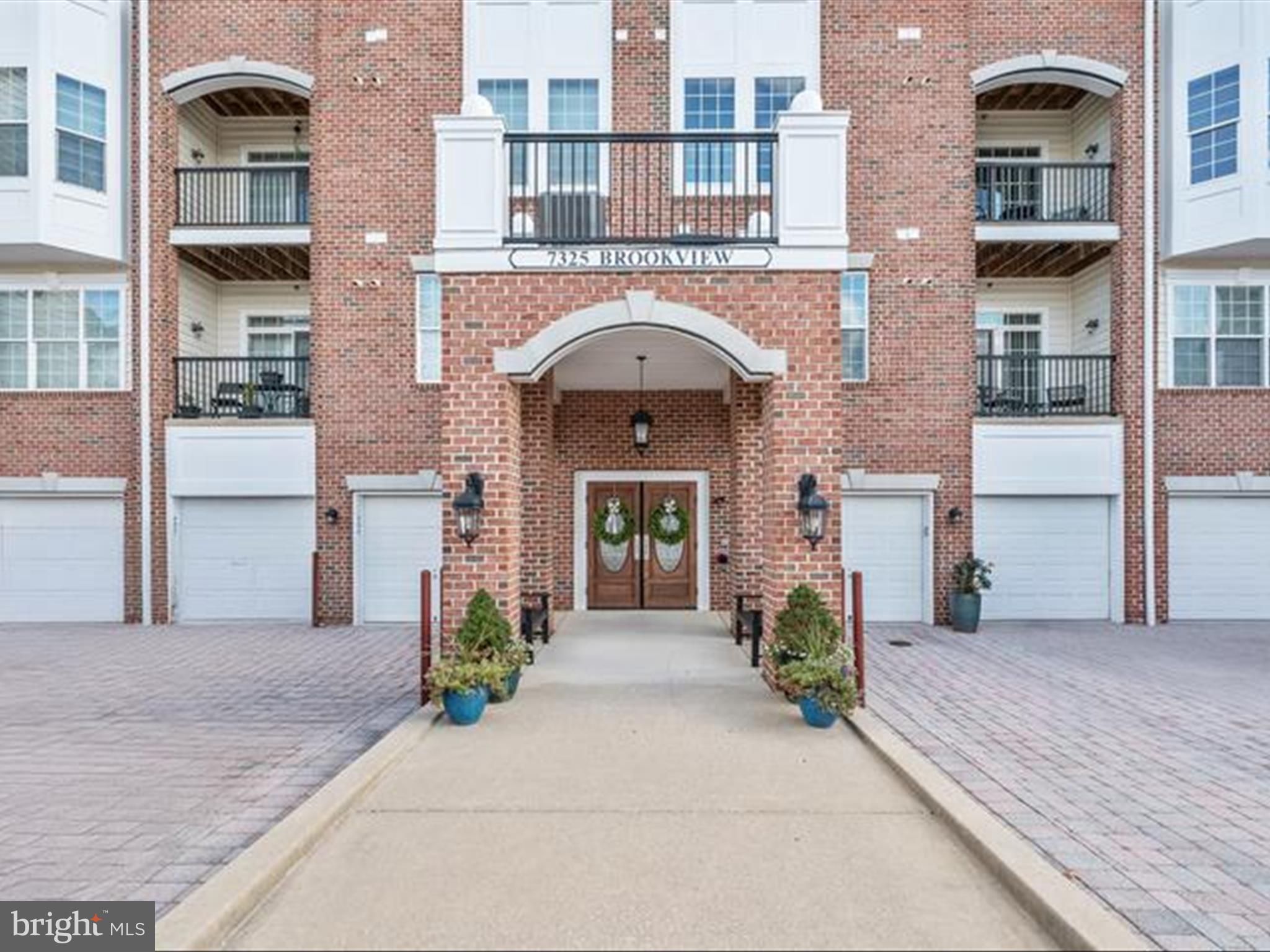 7325 Brookview Road, Unit 305 Elkridge, MD 21075 - Photo 35 of 40 a front view of a brick house with large windows