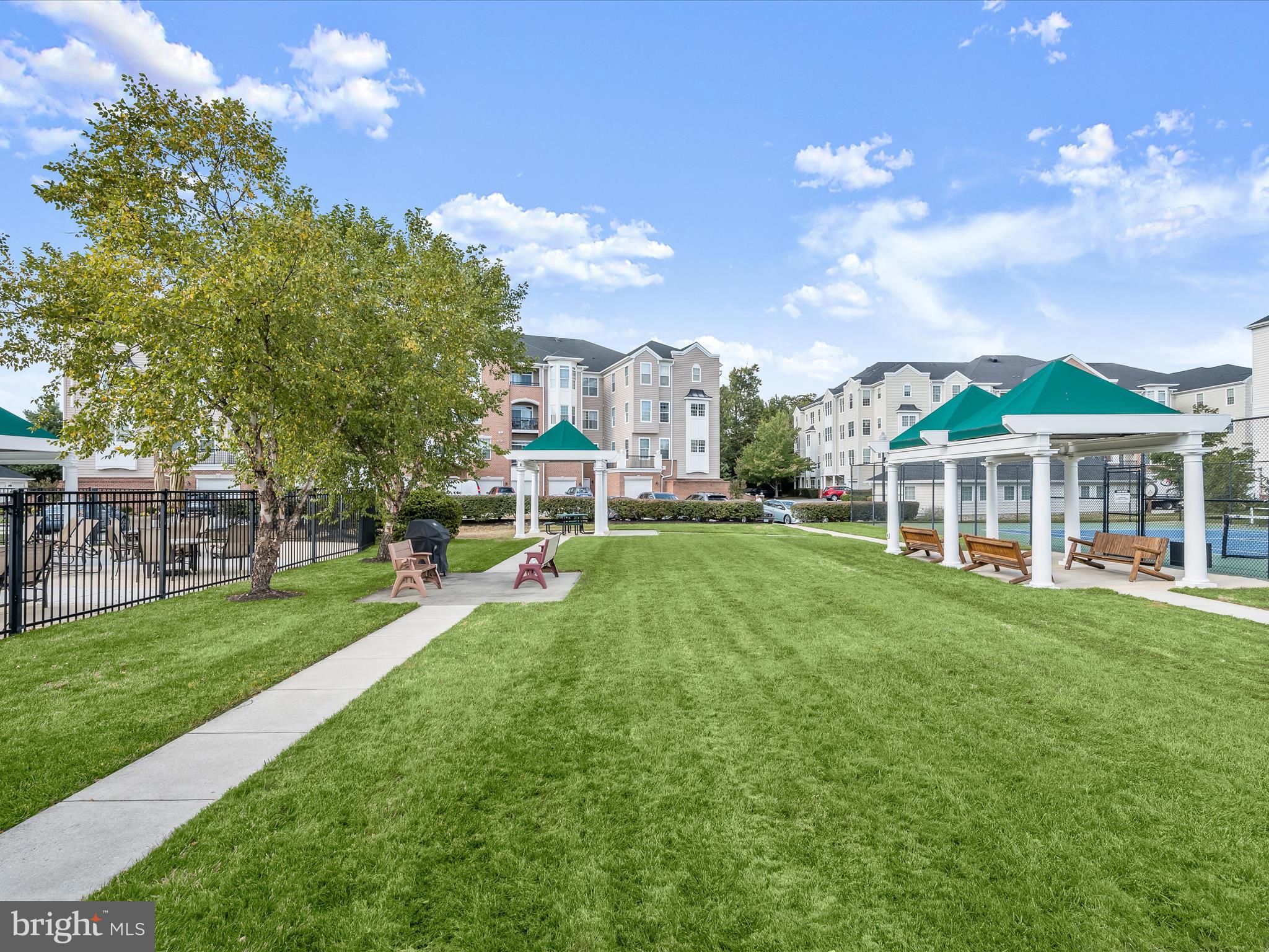 7325 Brookview Road, Unit 305 Elkridge, MD 21075 - Photo 37 of 40 a view of a big yard with table and chairs and a small yard