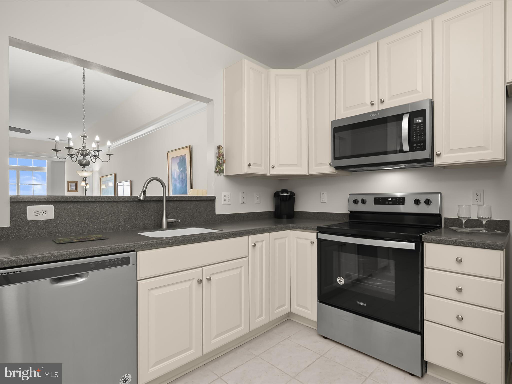 7325 Brookview Road, Unit 305 Elkridge, MD 21075 - Photo 5 of 40 a kitchen with granite countertop white cabinets white stainless steel appliances and a sink