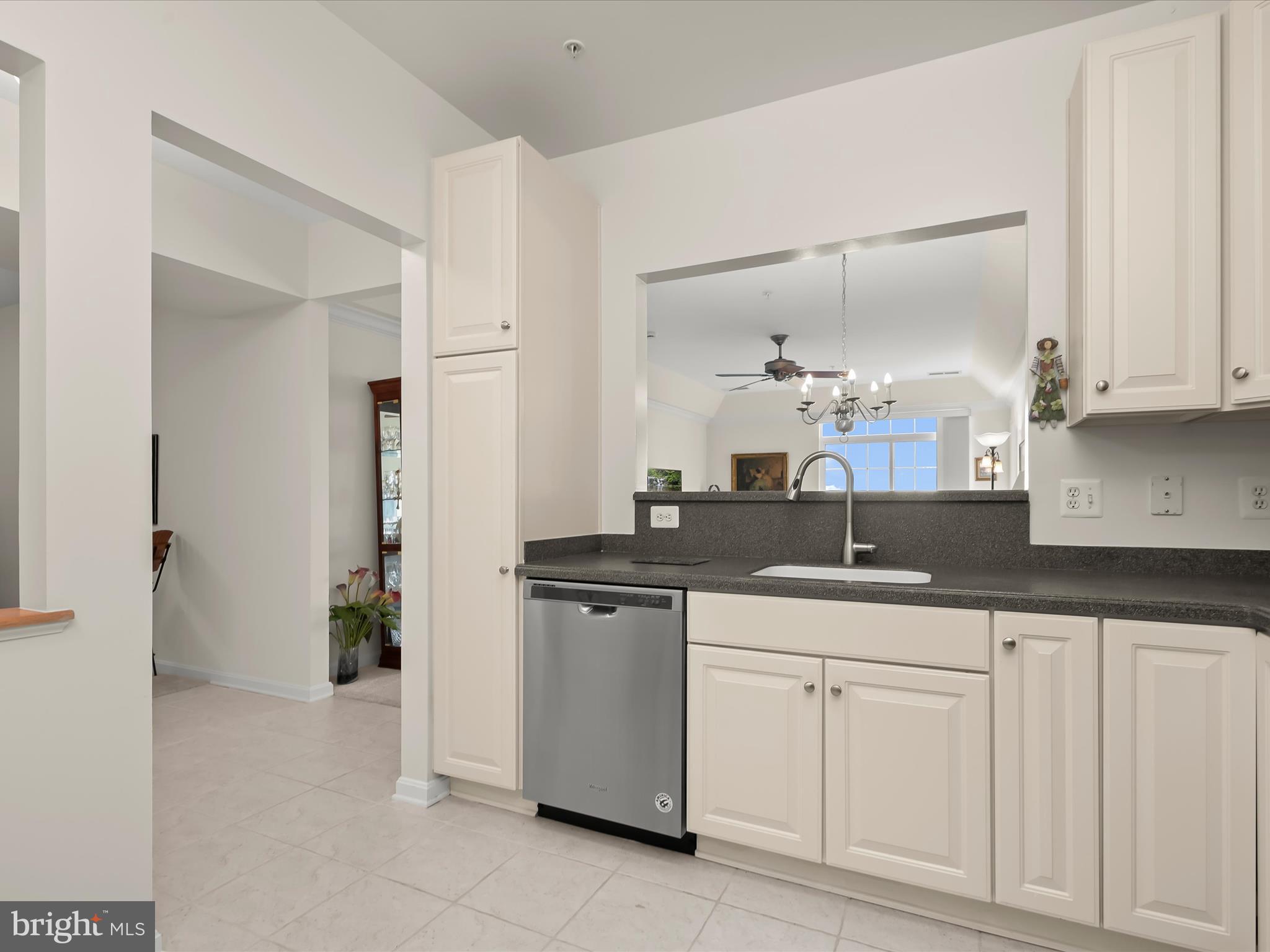 7325 Brookview Road, Unit 305 Elkridge, MD 21075 - Photo 8 of 40 a kitchen with granite countertop a sink and cabinets