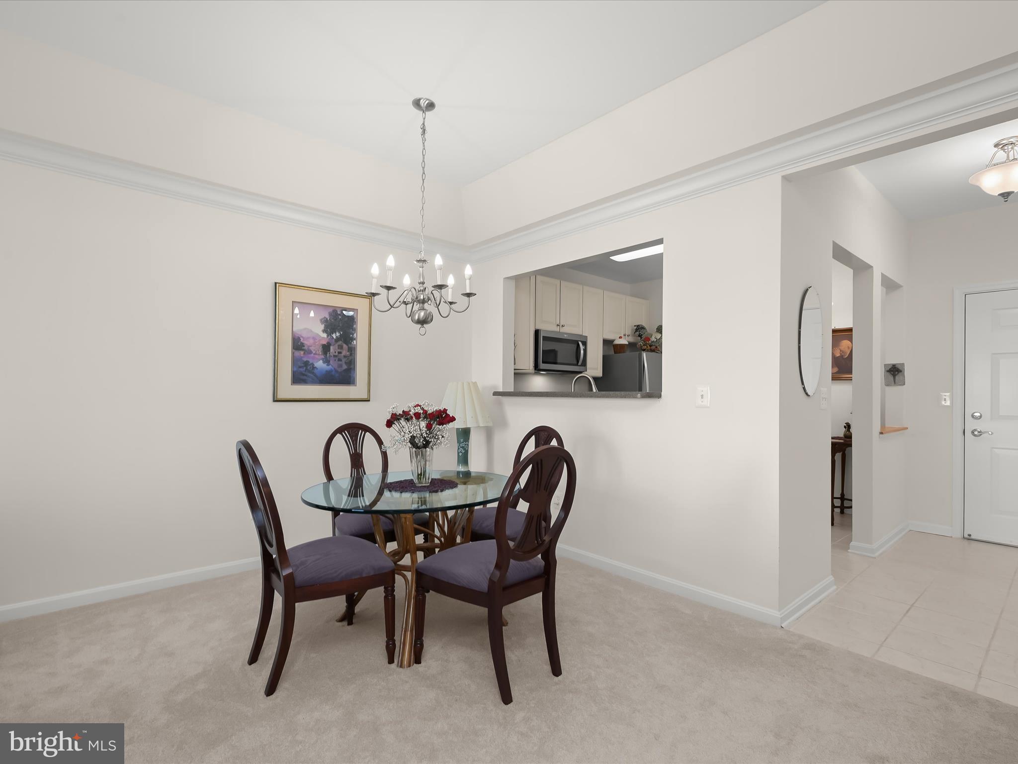 7325 Brookview Road, Unit 305 Elkridge, MD 21075 - Photo 10 of 40 a dining room with furniture a chandelier and window
