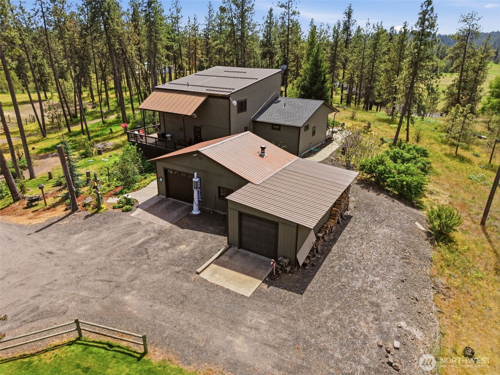 12119 South Spotted Road Cheney, WA 99004 - Photo 1 of 40 an aerial view of a house with yard and trees in the background