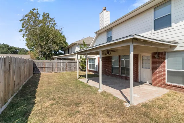 a view of house with backyard and deck