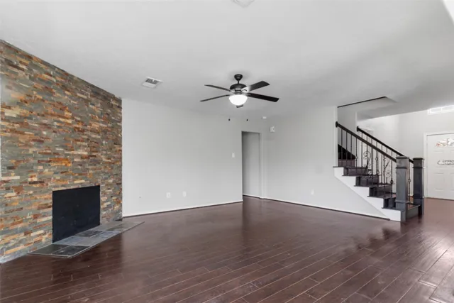 wooden floor in an empty room with a fireplace