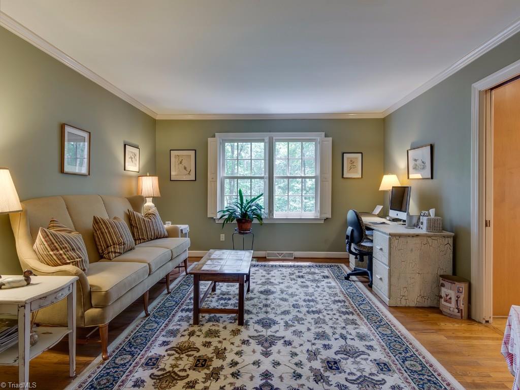 7103 Haw Ridge Road Summerfield, NC 27358 - Photo 3 of 30 Living Room with crown molding and wood floors.