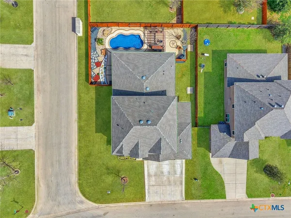 an aerial view of a house with a swimming pool