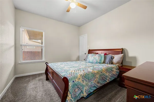 a bedroom with a bed and window