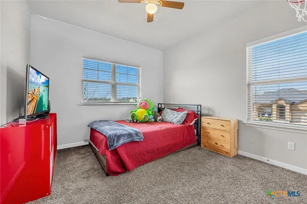 a bedroom with bed and a window