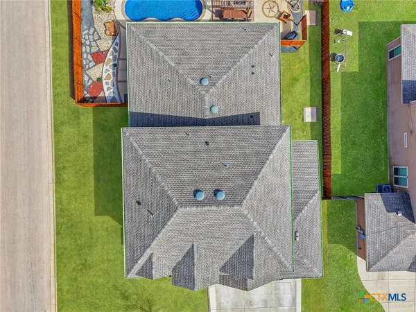 an aerial view of a house with a yard