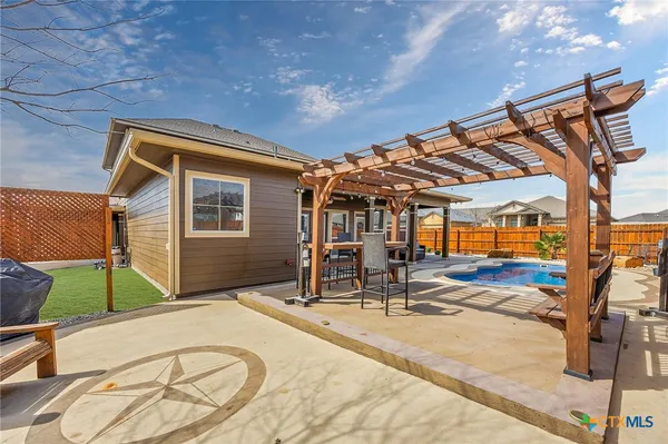 a view of a patio with a table and chairs under an umbrella with wooden floor