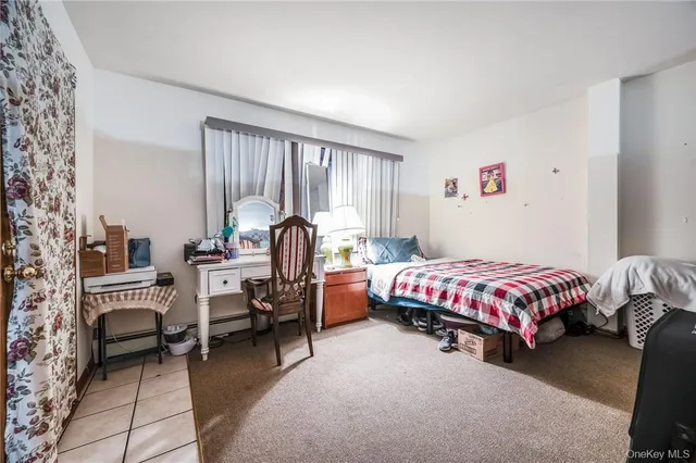 a bedroom with a bed and large windows