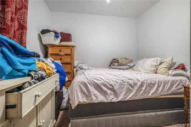 a bedroom with furniture and a flat screen tv