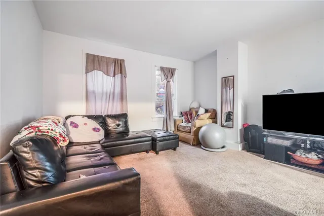 a living room with furniture and a book shelf