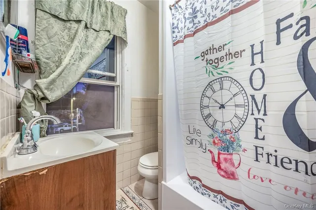 a view of a white house with a yard