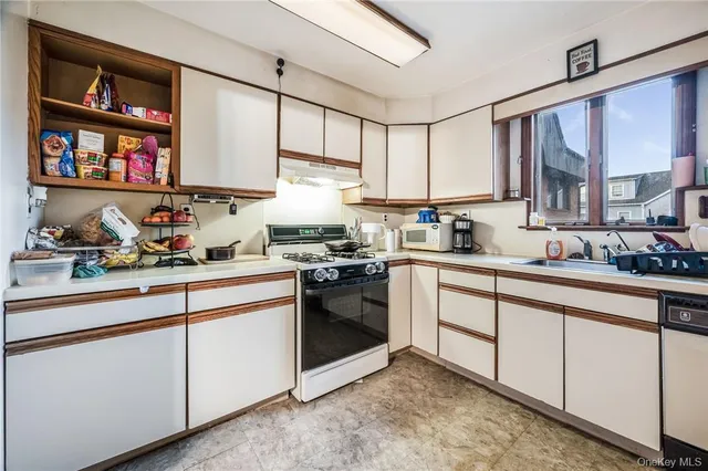 a white refrigerator freezer sitting inside of a kitchen