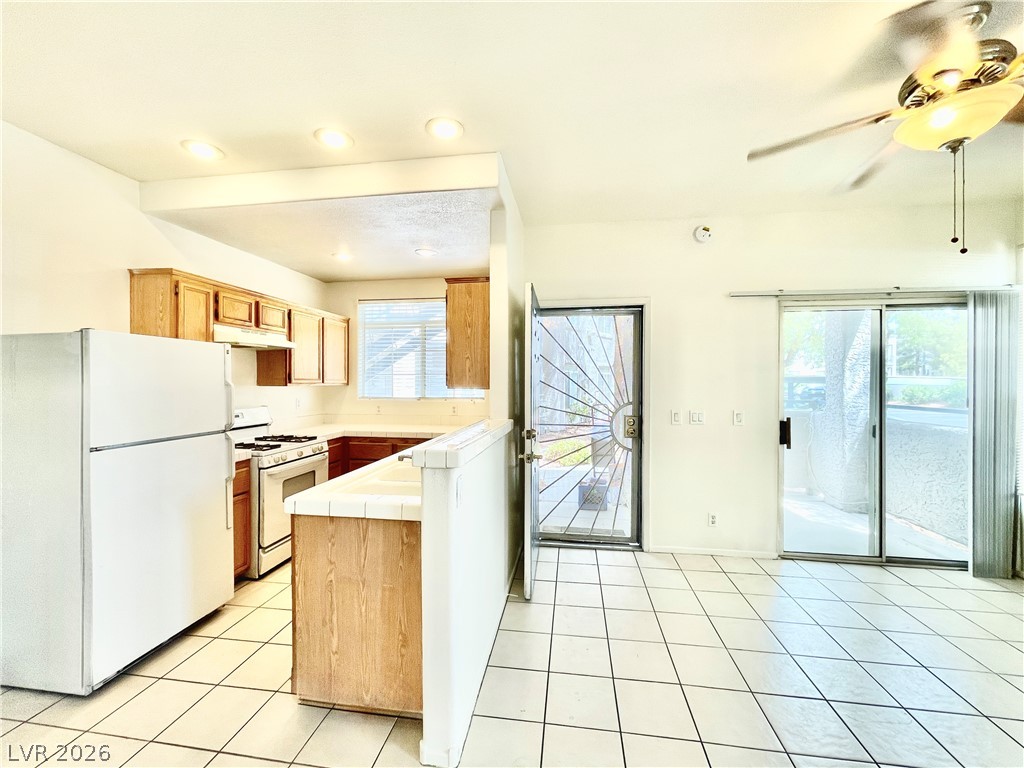 2201 Ramsgate Drive, Unit 915 Henderson, NV 89074 - Photo 20 of 36 A functional kitchen flows into an open living area with immediate access to outdoor space.
