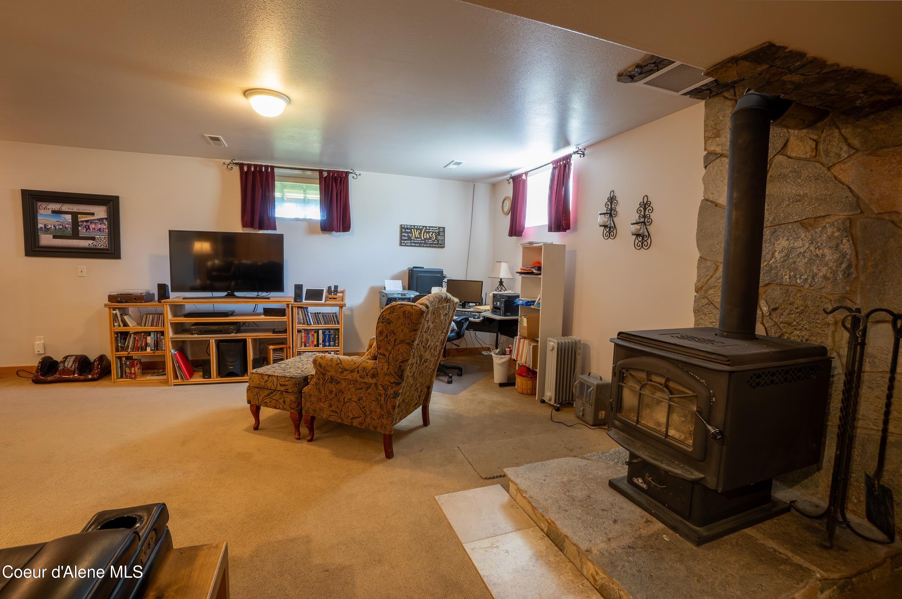 101 Zimmerman Road Moyie Springs, ID 83845 - Photo 25 of 39 Bsmnt Fam Rm w Wood Stove