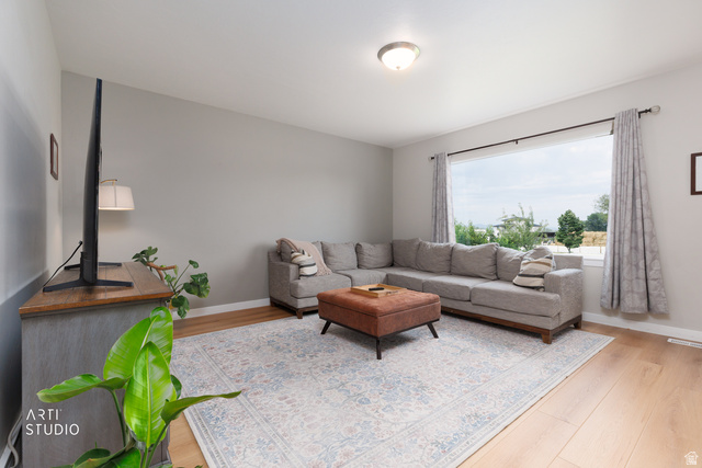 1654 South 730 West Provo, UT 84601 - Photo 5 of 33 Spacious room featuring light wood-finish flooring, a large picture window, and a built-in overhead light fixture