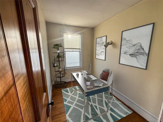 a workspace with wooden floor and furniture