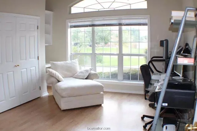 a living room with furniture and a floor to ceiling window