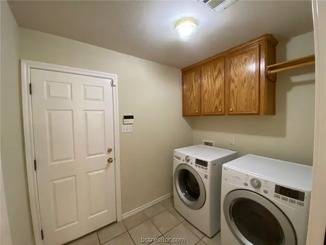 a view of a storage and utility room with washer and dryer
