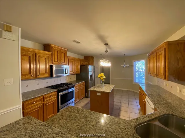 a large kitchen with stainless steel appliances
