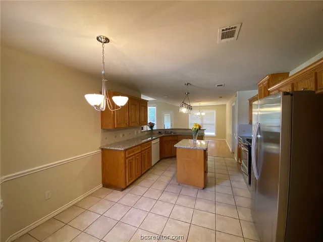 a kitchen with a sink and refrigerator