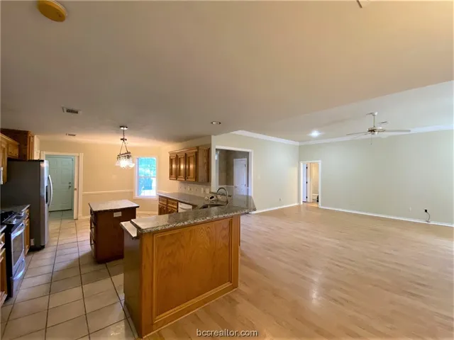 a kitchen with stainless steel appliances granite countertop a sink and cabinets