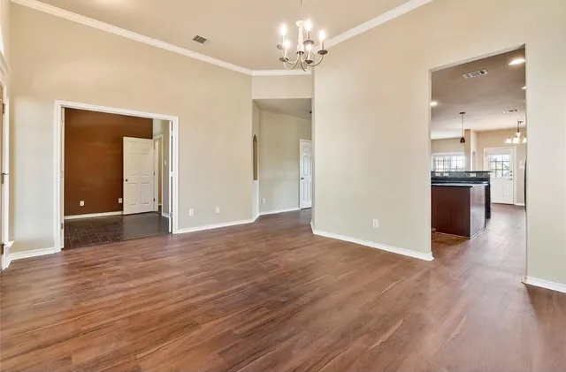 a view of a kitchen with wooden floor and a sink