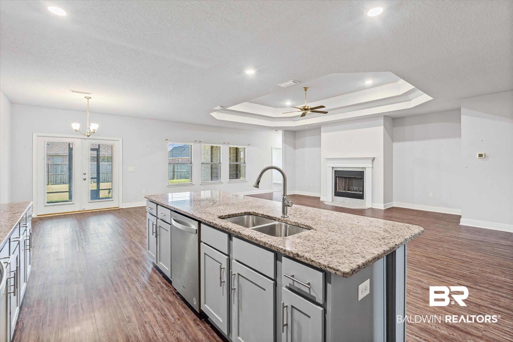 10207 Dunleith Loop Daphne, AL 36526 - Photo 22 of 23 Kitchen featuring gray cabinets, a fireplace with flush hearth, open floor plan, dark wood finished floors, and recessed lighting