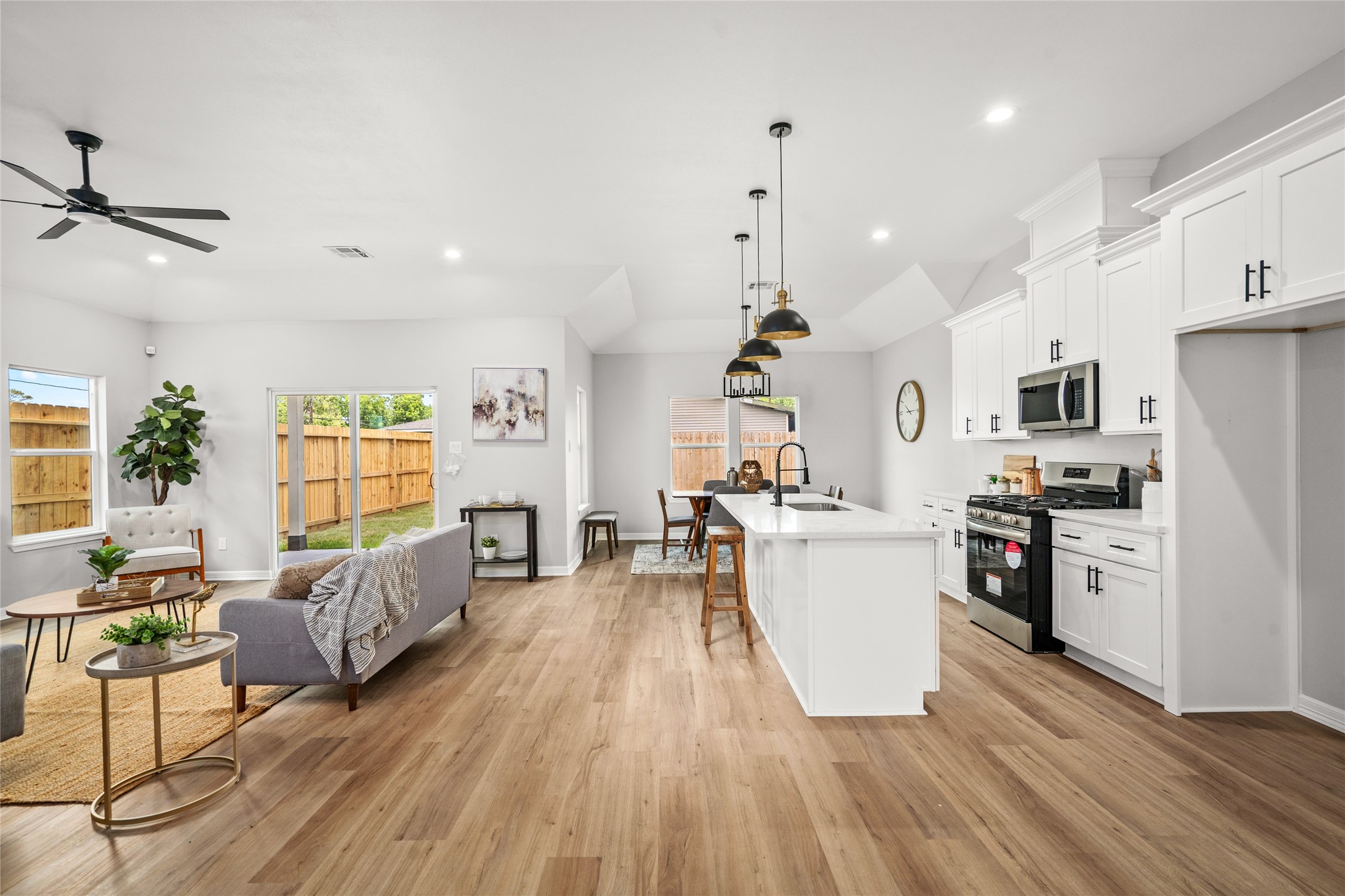 14307 Laredo Street Houston, TX 77015 - Photo 13 of 38 a kitchen with stainless steel appliances granite countertop a refrigerator a stove top oven a dining table and chairs with wooden floor