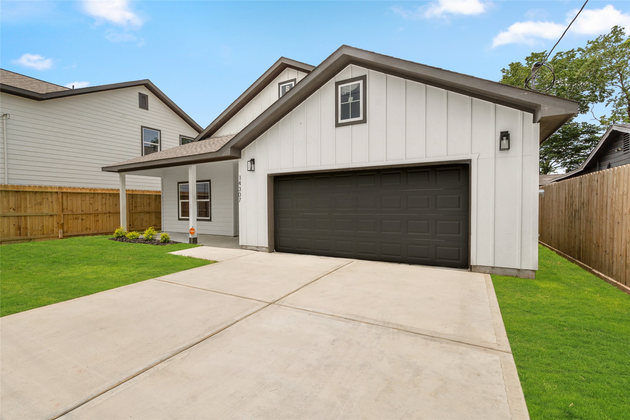 14307 Laredo Street Houston, TX 77015 - Photo 37 of 38 a front view of a house with a yard and garage