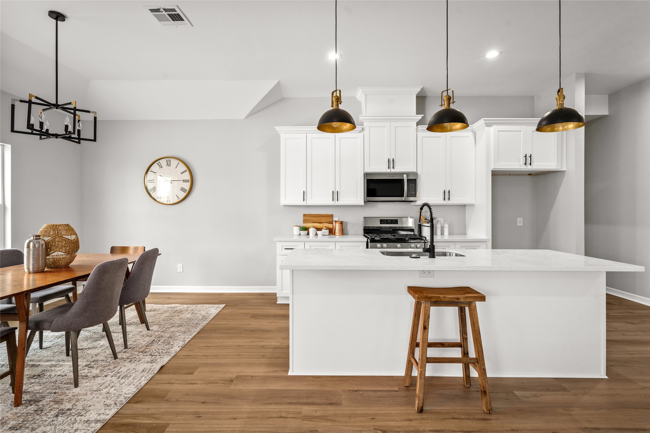 14307 Laredo Street Houston, TX 77015 - Photo 4 of 38 a kitchen with kitchen island stainless steel appliances a stove center island a dining table and chairs