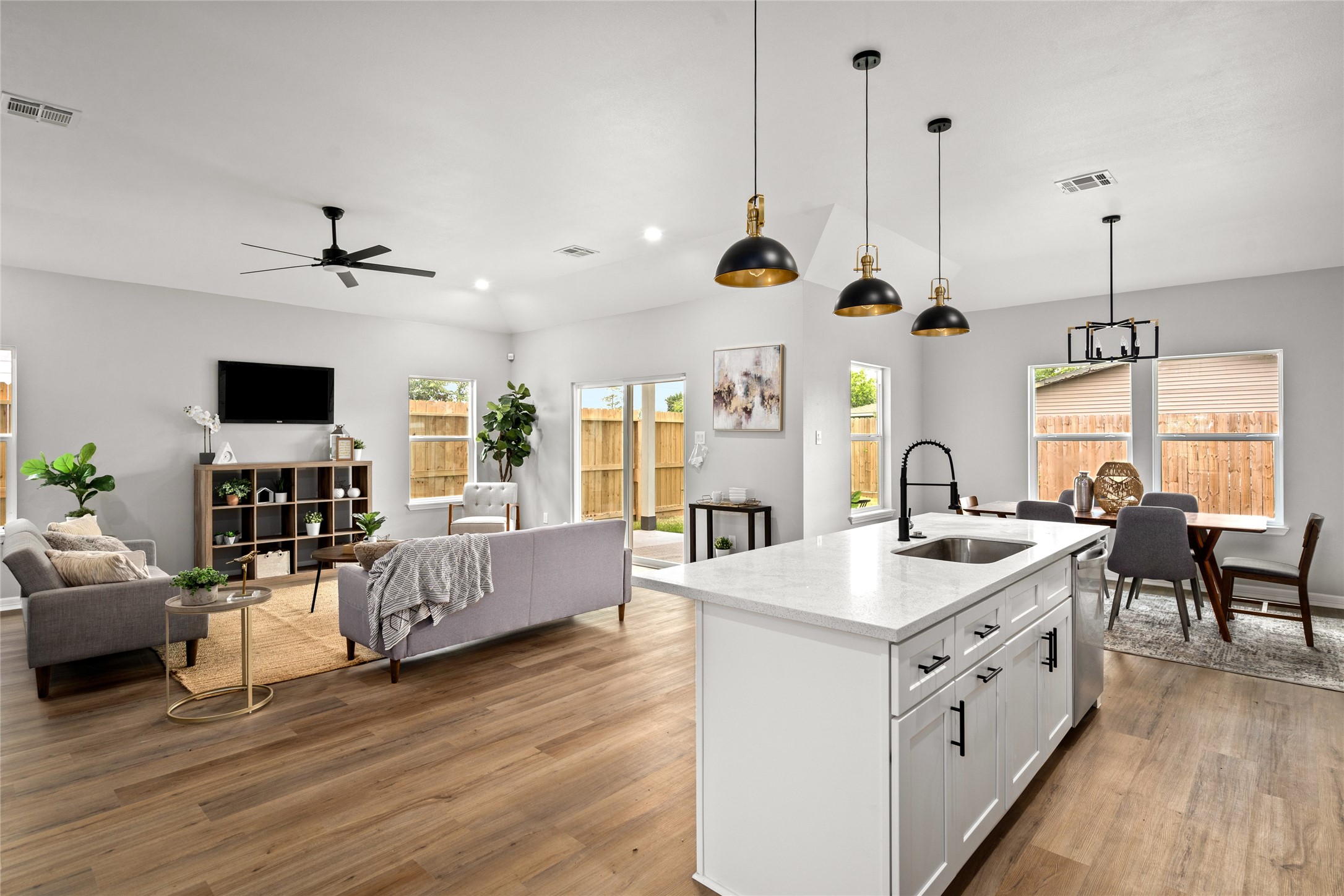 14307 Laredo Street Houston, TX 77015 - Photo 38 of 38 a large kitchen with stainless steel appliances kitchen island granite countertop a sink dishwasher a dining table and chairs with wooden floor