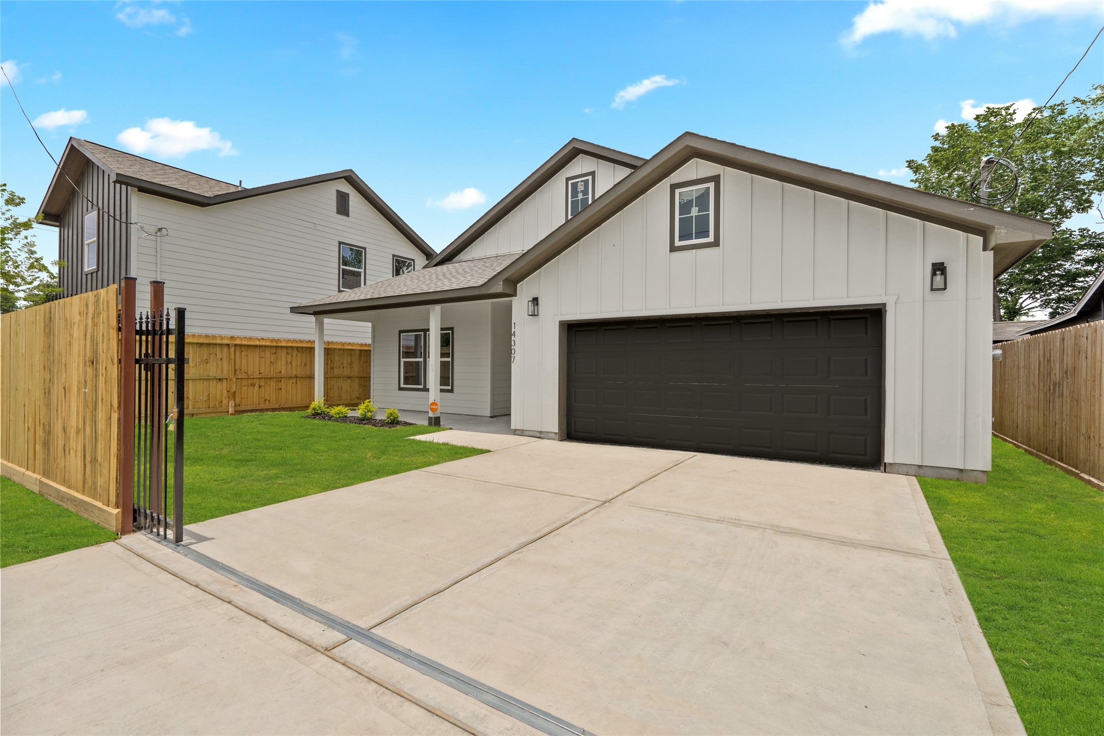 14307 Laredo Street Houston, TX 77015 - Photo 9 of 38 a front view of a house with a yard and garage