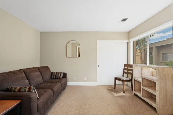a bedroom with a bed wooden floor and window