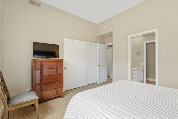 a bedroom with a bed and a tv