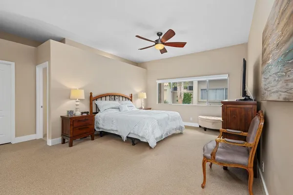 a living room with patio furniture and a large window