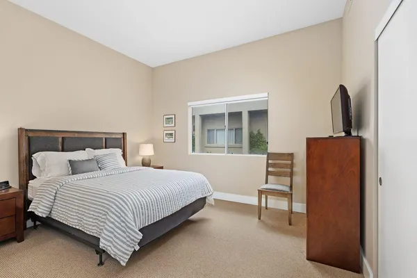 a bedroom with a bed a desk and chair