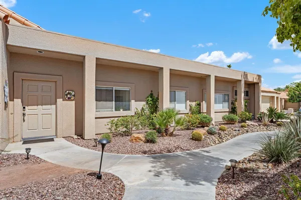 a living room with furniture a ceiling fan and a window