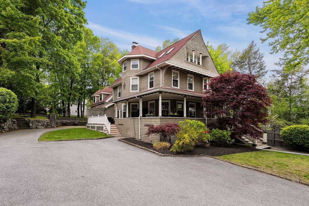 165 Park Avenue, Unit 165 Arlington, MA 02476 - Photo 25 of 32 a front view of a house with a yard table and chairs